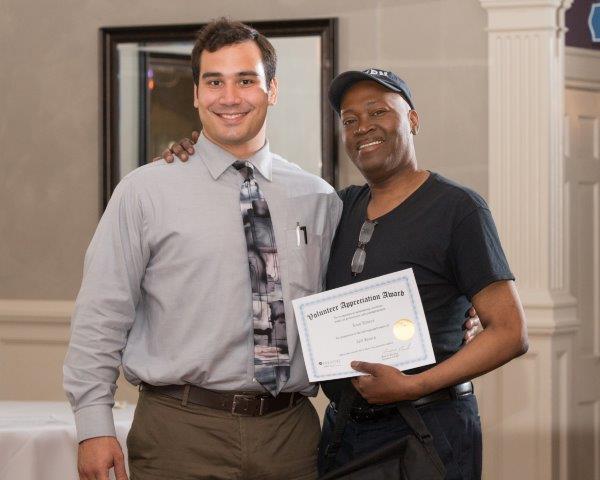 Two Men Posing with Certificate